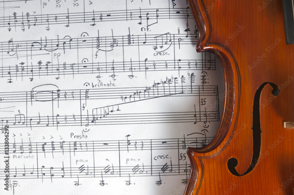 Fototapeta premium Music notes and violin on table