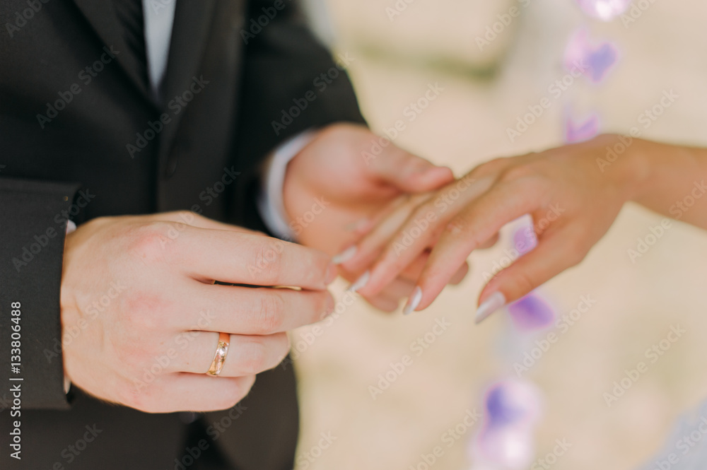 picture of man putting wedding ring on woman hand picture of man putting wedding ring on woman hand