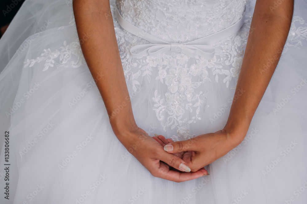 A bride is holding the beautiful jewelry (earrings, pendant) in the hand A bride is holding the beautiful jewelry (earrings, pendant) in the hand