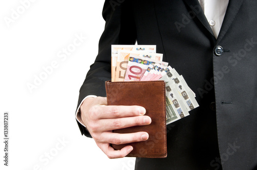 man's hand pulling cash from the wallet photo