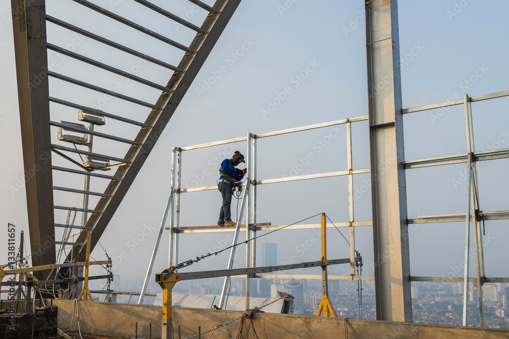 Asian worker weld on top of high building without scaffolding, low safety working condition Asian worker weld on top of high building without scaffolding, low safety working condition