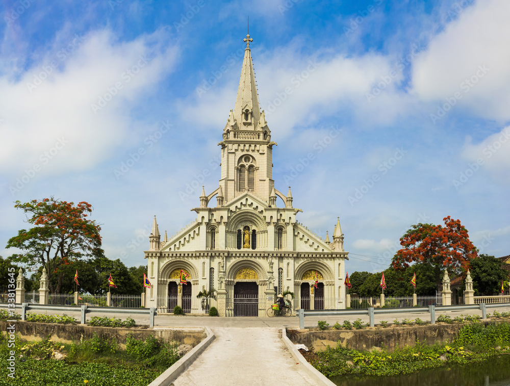 Panorama view of a commune church in Kim Son district, Ninh Binh province, Vietnam. The building is a travel destination for tourist visiting Ninh Binh