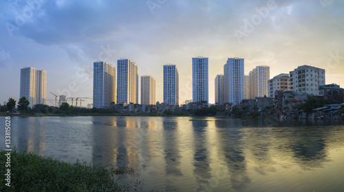 Apartment with reflection on lake. Hanoi buildings