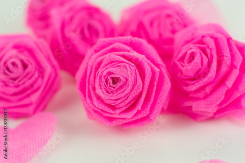 Fototapeta Naklejka Na Ścianę i Meble -  Pink rose fabric flower and small hart on white background for V