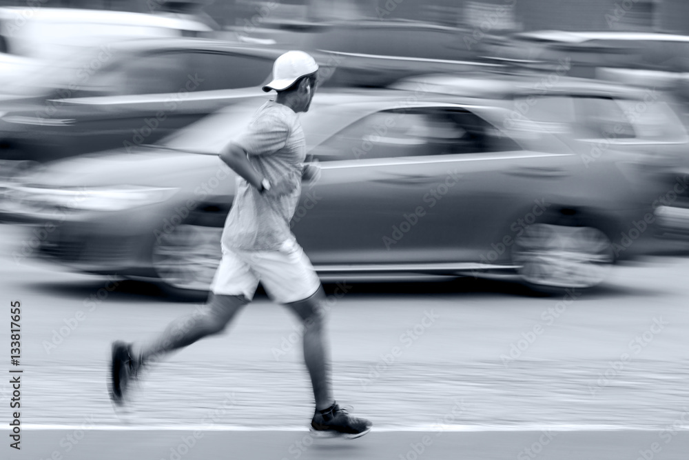 athlete runner on city street in blue tonality