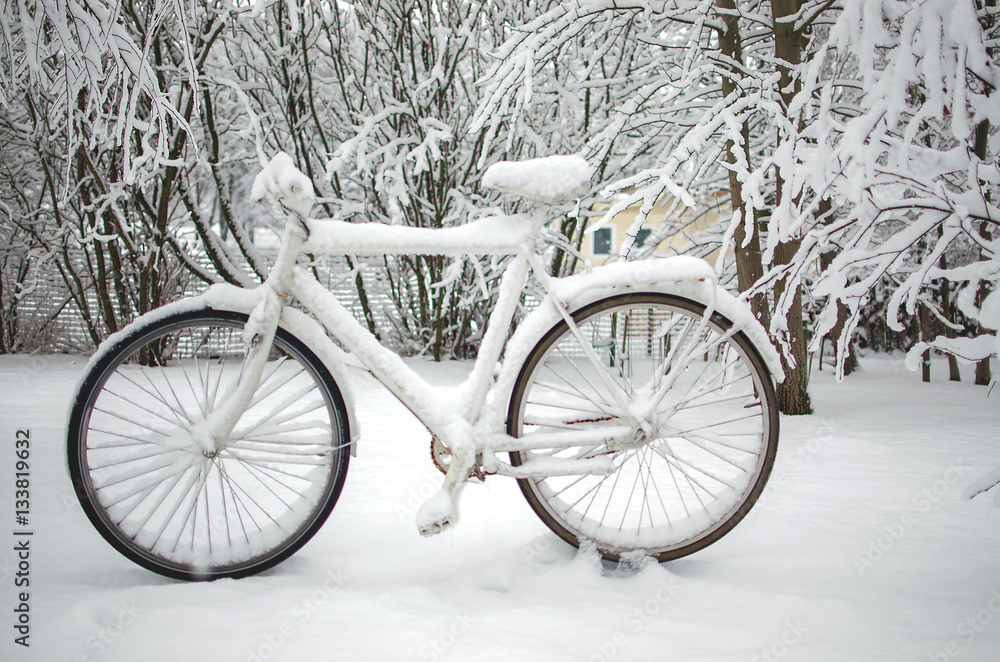 Bike under the snow, in the Park winter