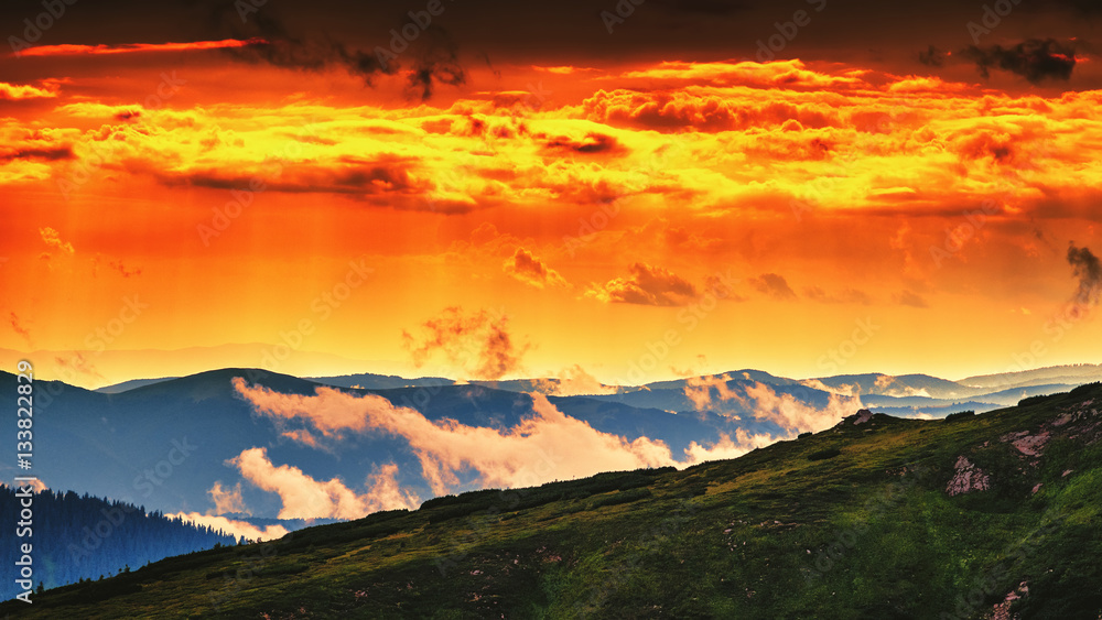 Red, orange sky in sunset evening time, picturesque and dramatic Carpathian mountains landscape, Ukraine.