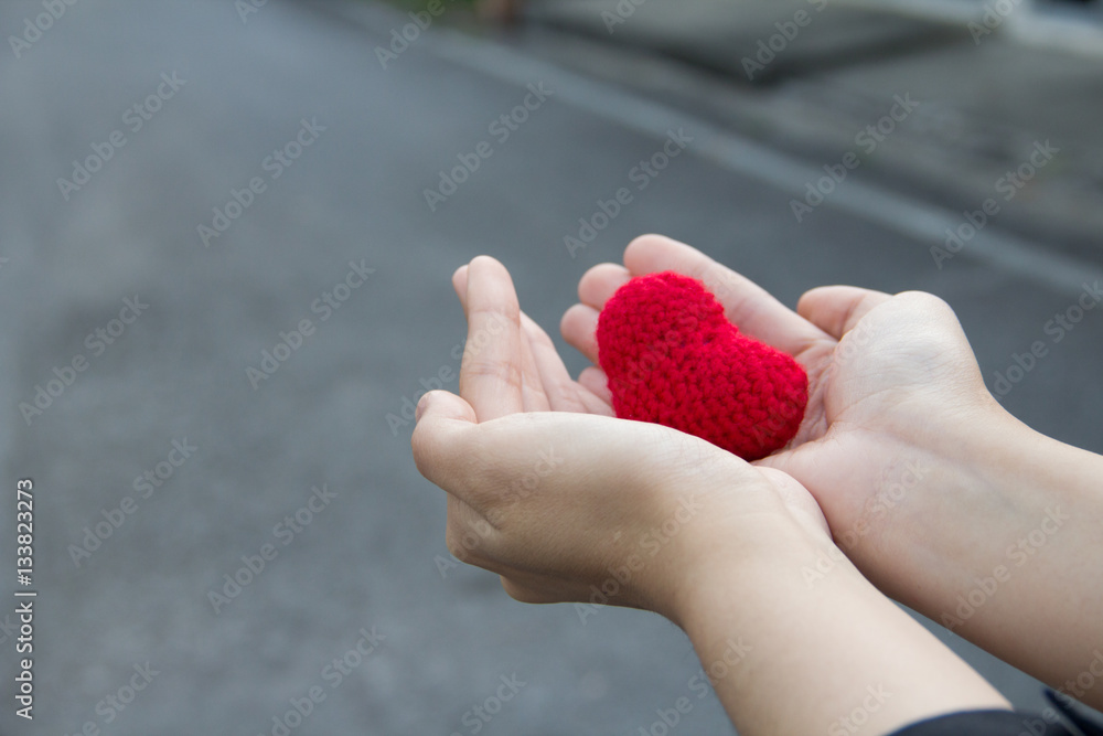 Heart on woman hand bluured background Heart on woman hand bluured background