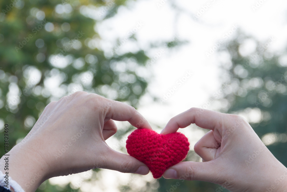 Woman finger made heart on white bokeh background Woman finger made heart on white bokeh background