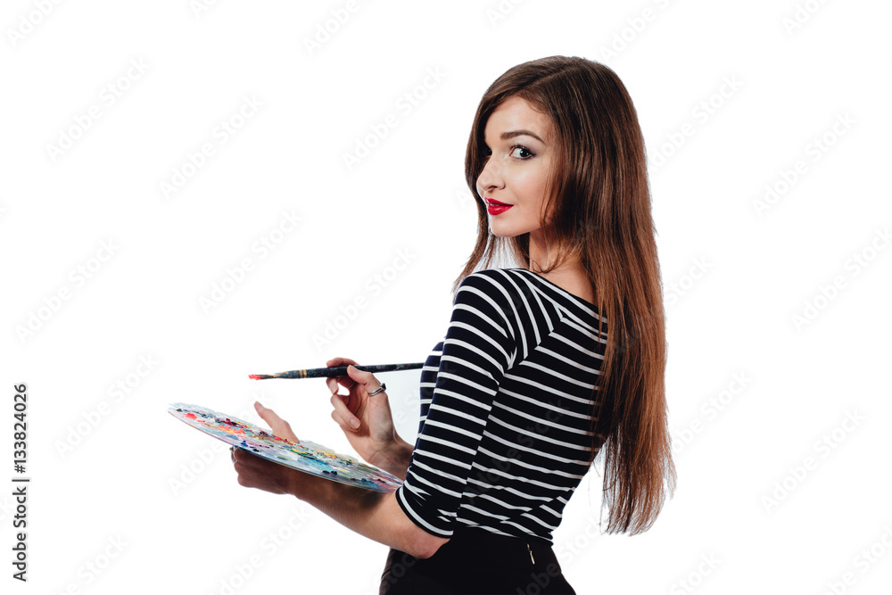 Cute beautiful girl artist holding a palette and brush in the process draws inspiration. White background, isolated. Cute beautiful girl artist holding a palette and brush in the process draws inspiration. White background, isolated.