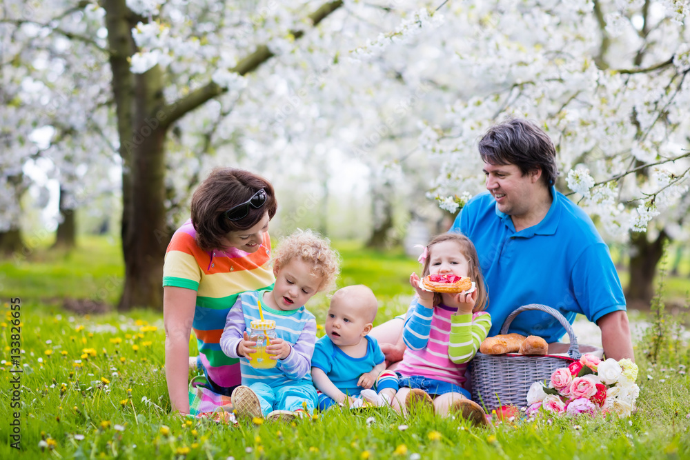 Fototapeta premium Family with children enjoying picnic in spring park