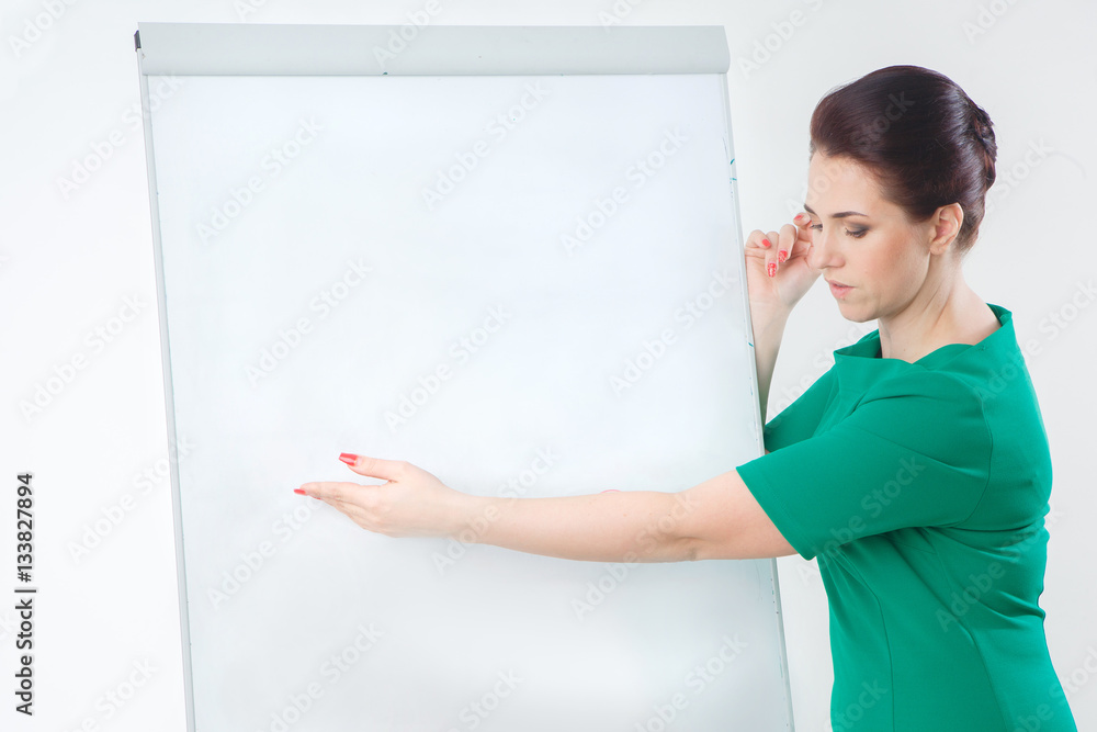 Full length portrait of a happy beautiful businesswoman standing with blank flipchart isolated on a white background. Looking at camera Full length portrait of a happy beautiful businesswoman standing with blank flipchart isolated on a white background. Looking at camera