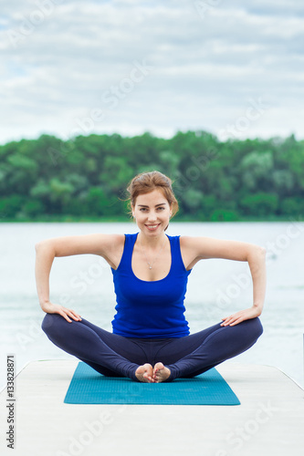 Young woman doing yoga exercise on mat 32