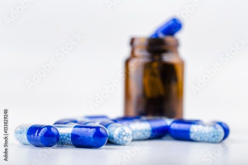 Bunch of blue pills with glass ampoules