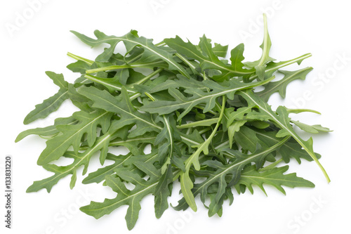 Close up studio shot of green fresh rucola isolated on white bac