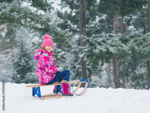 Konstfotografi Child play in snow with sled