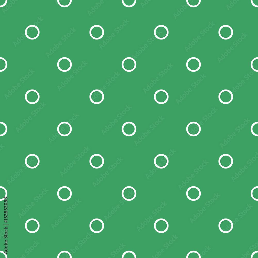 A pattern of white linear circles on a green background