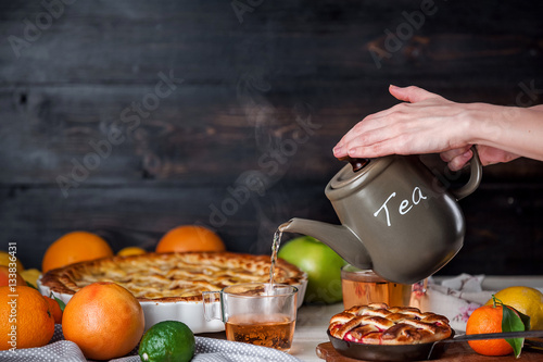 cake filled with jam and slices of citrus mandarin photo