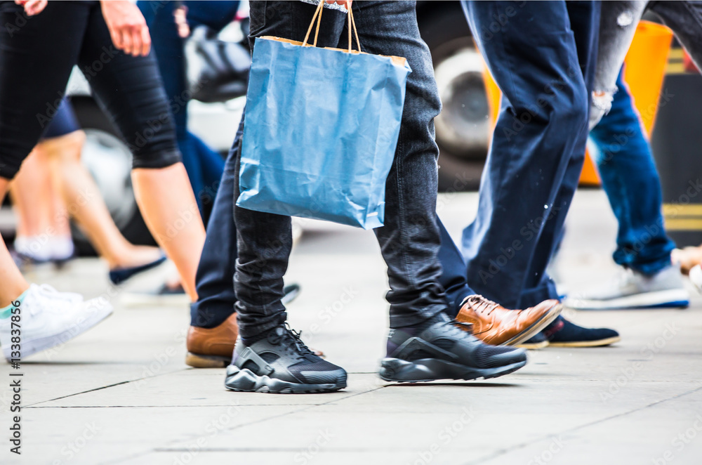 Feet of pedestrians walking on the crosswalk in Oxford street, London. Modern life, travel and shopping concept Feet of pedestrians walking on the crosswalk in Oxford street, London. Modern life, travel and shopping concept
