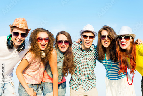 group of young people wearing sunglasses and hat © adam121