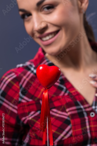 Red heart in woman hands.