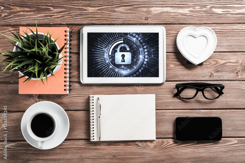 Web security and technology concept with tablet pc on wooden tab Web security and technology concept with tablet pc on wooden tab