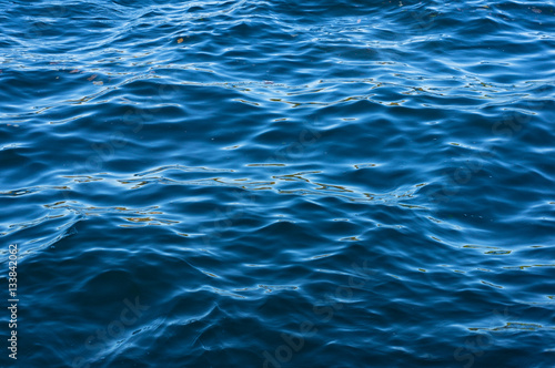 Blue tones water surface, texture background © Olga K
