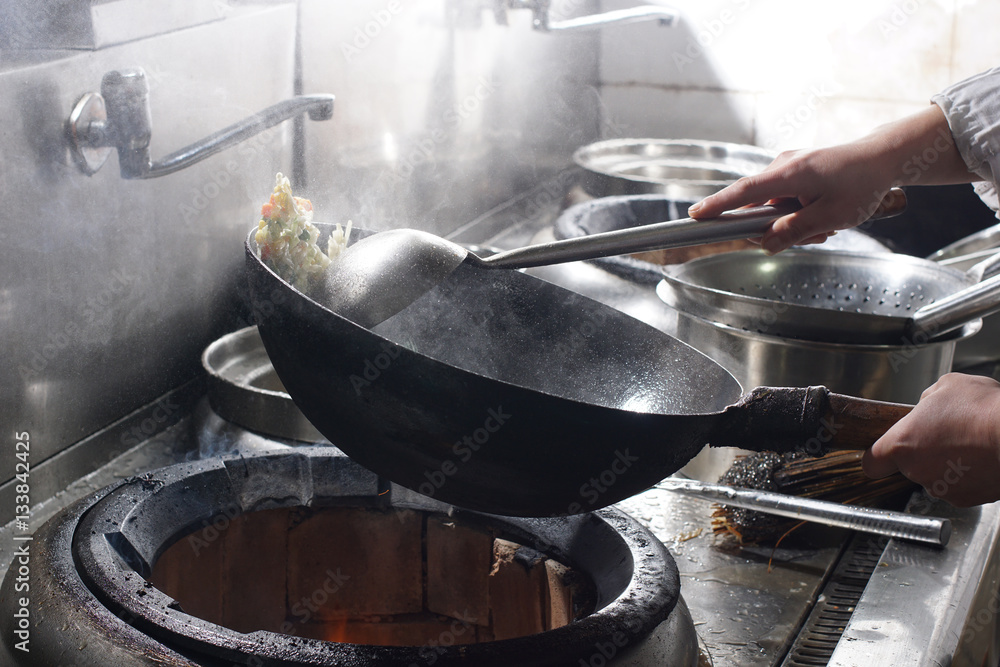 Close up of working chef preparing chinese food