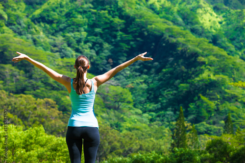 Feeling free! Happy healthy woman outdoors in a green nature setting. 