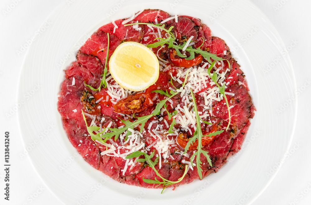 Carpaccio on a plate on a white background,top view closeup
Carpaccio on a plate on a white background,top view closeup