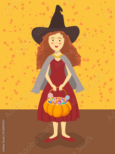 Cute girl with witch costume in Halloween event is carrying pumpkin bag with a lot of candies.