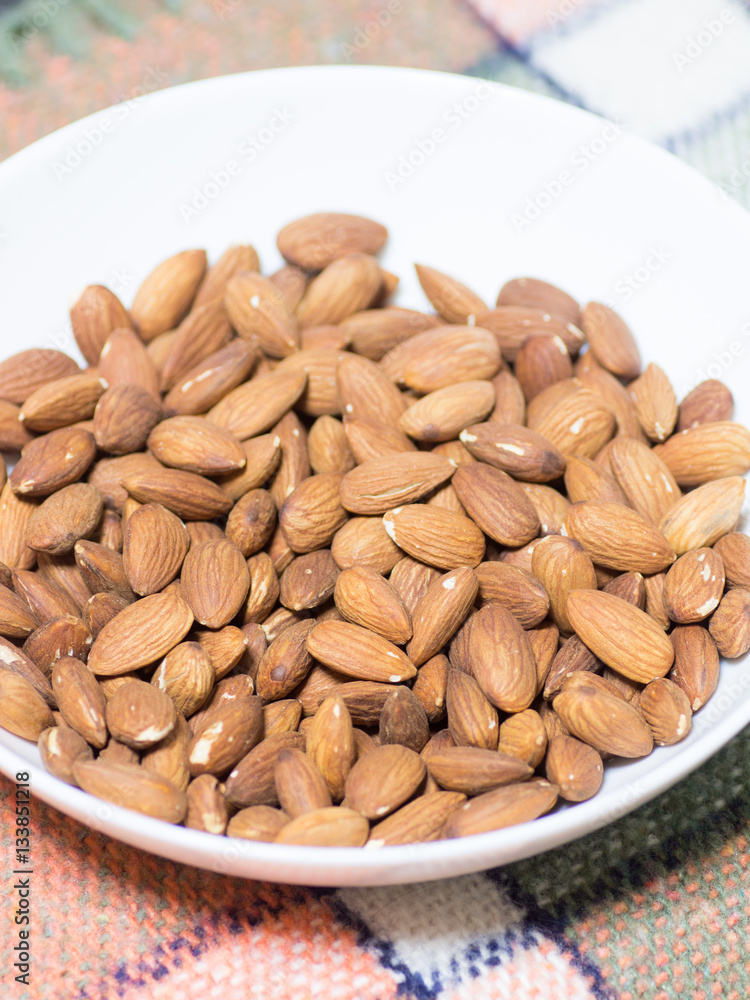 Pile of almonds in the white bowl
