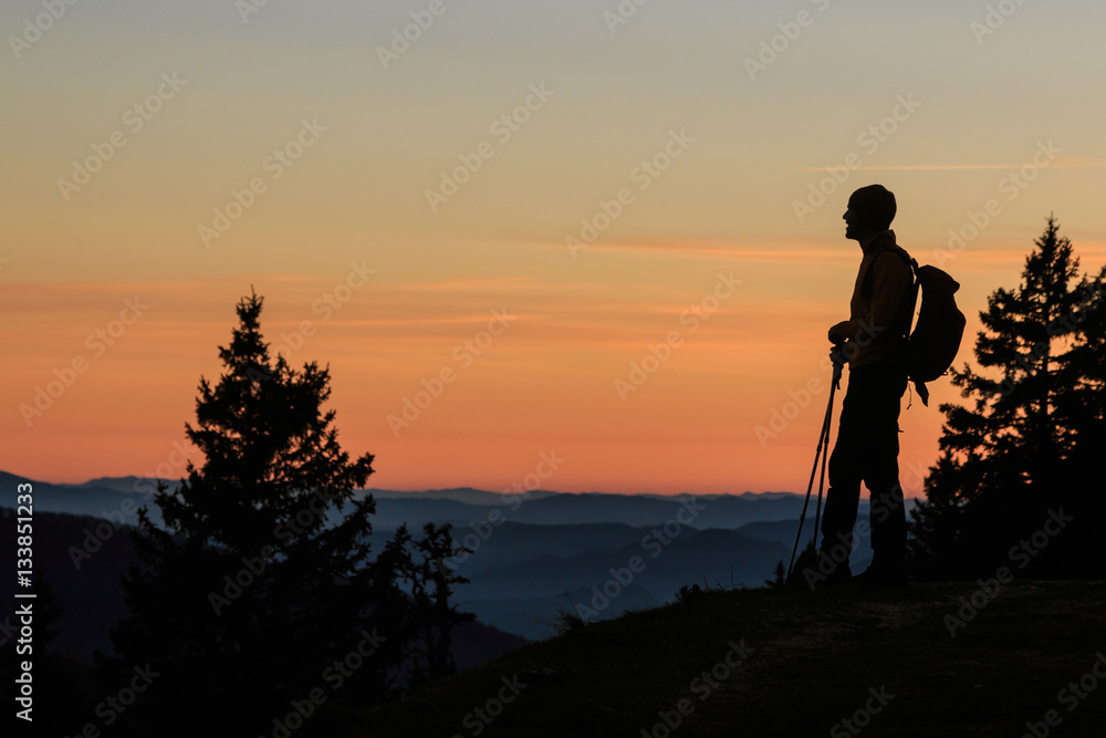 Mountaineer silhouette at the sunset on the Kosuta ridge in Karavanke range, Slovenia