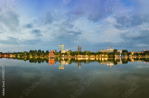 Hoan Kiem lake panorama view at sunset period with ancient Turtle Tower and Hanoi post office (Buu Dien Ha Noi in Vietnamese) . Hoan Kiem lake (Sword lake or Ho Guom) is center of Hanoi