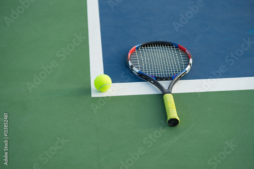 Tennis ball and racket on tennis court © Hanoi Photography