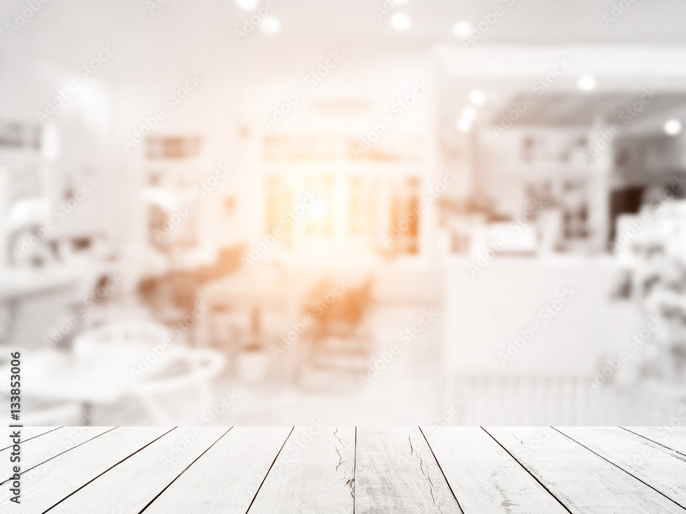 White above wood floor focus to table top in the foreground. Abstract blurred of restaurant shop pastel background. Counter cafes and coffee service. Food and Beverage Modern. White above wood floor focus to table top in the foreground. Abstract blurred of restaurant shop pastel background. Counter cafes and coffee service. Food and Beverage Modern.
