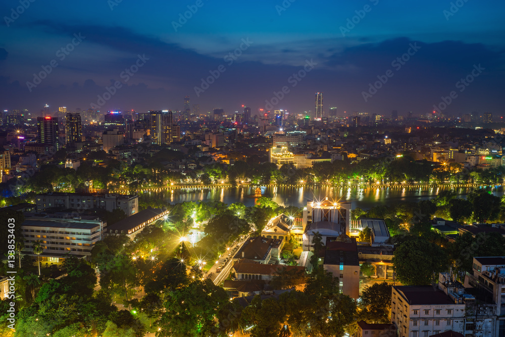Fototapeta premium Aerial view of a Hoan Kiem lake ( Sword lake, Ho Guom in Vietnamese ) at night. Hanoi skyline view. Hoan Kiem lake is center of Hanoi