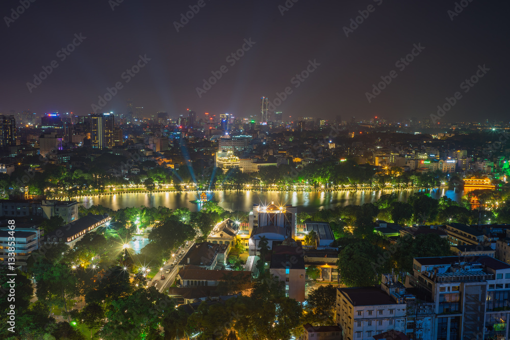 Aerial view of a Hoan Kiem lake ( Sword lake, Ho Guom in Vietnamese ) at night. Hanoi skyline view. Hoan Kiem lake is center of Hanoi