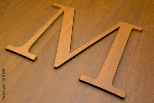 Wooden letter M on wood background, 3d illustration