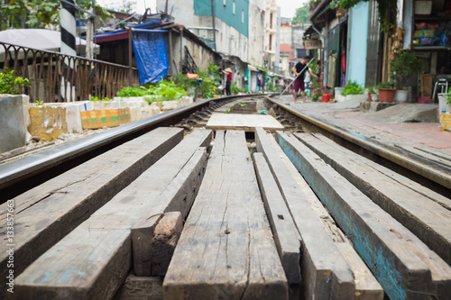 Wooden path crossing railway rail in Vietnam. Concept of unsafe railway