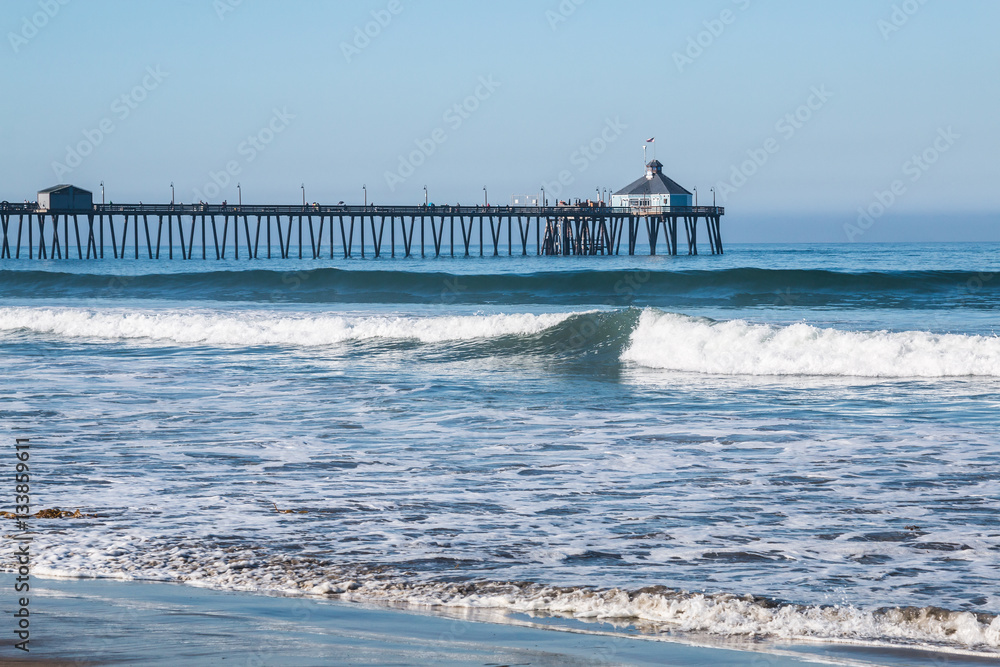 Imperial Beach, California fishing pier with beach and waves in foreground.