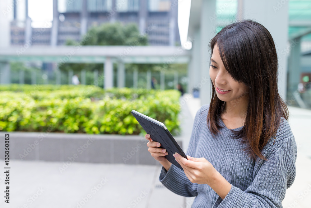 Woman looking at digital tablet at outdoor Woman looking at digital tablet at outdoor