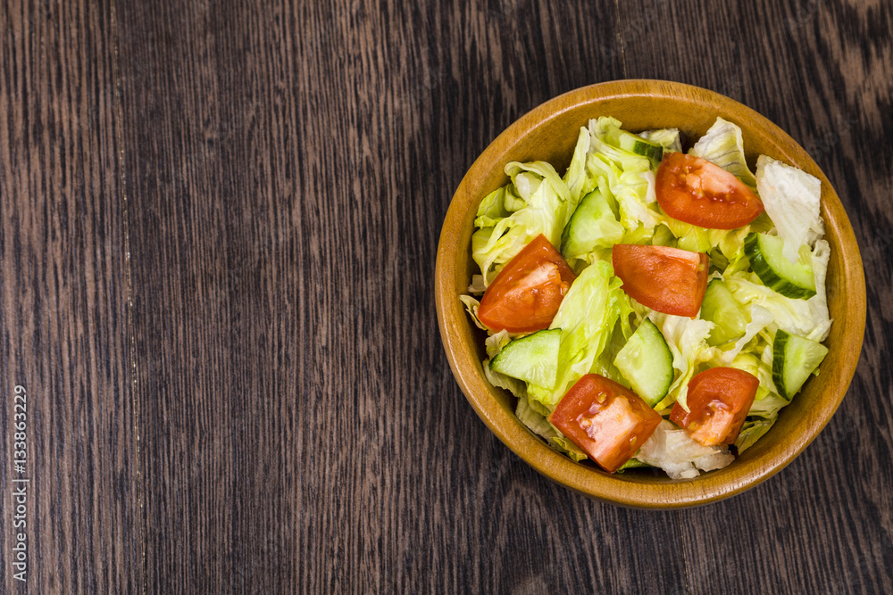 Salad in wooden bowl on a table close-up. Concept of healthy nut Salad in wooden bowl on a table close-up. Concept of healthy nut