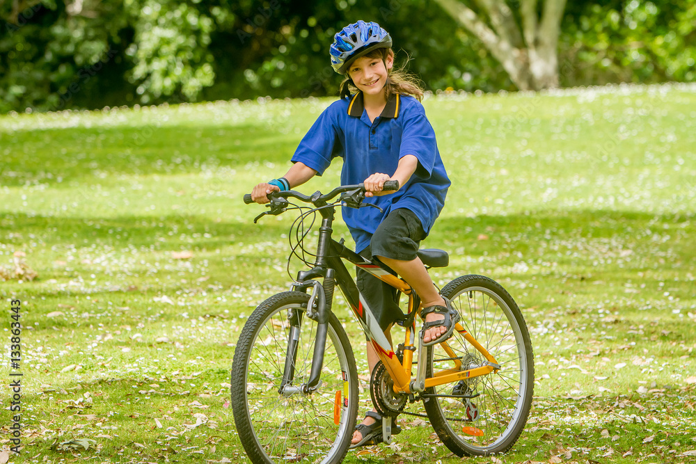 young happy preteen child boy riding a bicycle on natural park b young happy preteen child boy riding a bicycle on natural park b