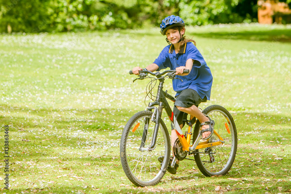 young happy preteen child boy riding a bicycle on natural park b young happy preteen child boy riding a bicycle on natural park b