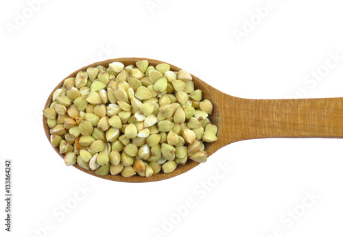 Green buckwheat on wooden spoon