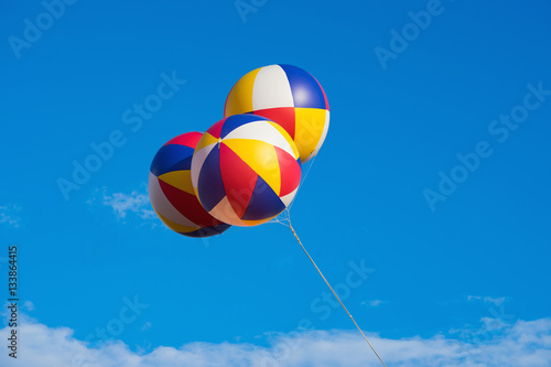 Three big balloons against blue sky