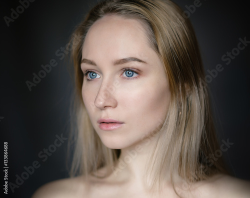 Portrait of a beautiful young woman with blue eyes.