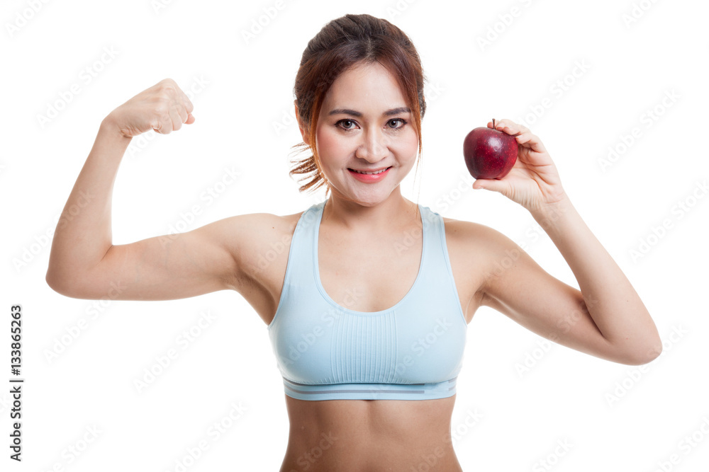 Beautiful Asian healthy girl flexing biceps with apple. Beautiful Asian healthy girl flexing biceps with apple.