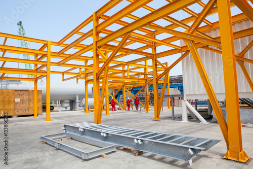 Yellow steel construction in open at factory.